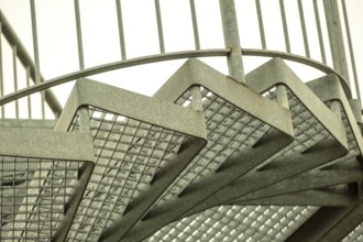 Details of a metal spiral staircase in an industrial building