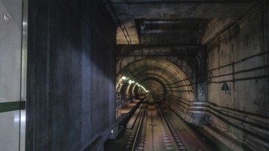 View on rails in metropolitan tube in lamps light