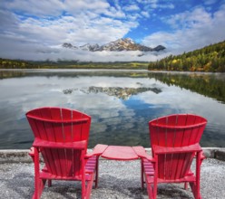 Two red sun loungers are on the Pyramid Lake. Concept of vacation and tourism