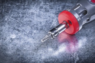 Threaded screwdriver on metallic background close up view construction concept