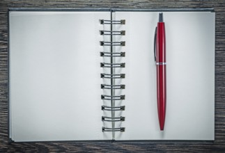 Spiral notepad ballpoint pen on vintage wooden board
