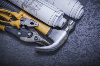 Construction drawings steel cutter pliers claw hammer on black background