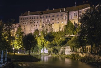 View of Cesky Krumlov castle from Vltava river at night, Czech republic