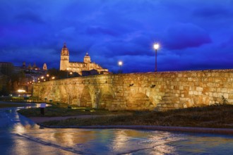Salamanca skyline sunset and roman bridge over Tormes river in Spain