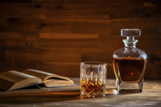 A glass of rum and an old book in a bar in Cuba