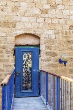 Doors bound by metal bars. Sunset. Old Yaffo - one of the most ancient cities of the world. Warm