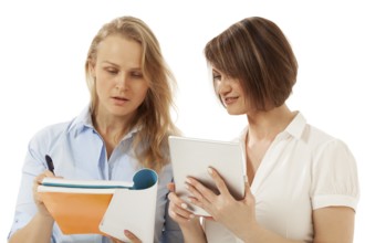 Two colleagues looking at notebook. White background. Isolated, studio shot