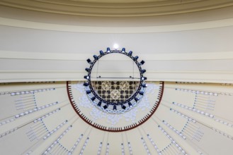View to the ceiling of a building with modern chandelier and geometric patterns, Prague, Railway