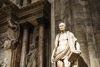 Statue of Saint Bartholomew with a book in his hands in the Duomo. Italy, Milan.