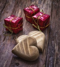 Hand-carved symbolic wooden heart on a background of yellow roses
