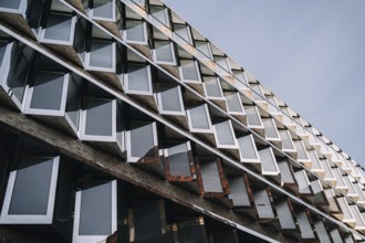 Photo of modern futuristic architecture with metal and glass window patterns