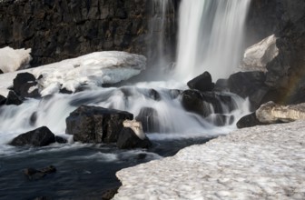 Water from waterfall splashing on a rocky river. The Oxararfoss waterfall in pingvellir Thingvellir