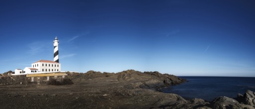 A panorama landscape of the Favaritx Lighthouse on the west coast of Menorca