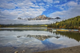 Boat station with motor boats waiting for tourists. Cold morning in the Rocky Mountains, Jasper