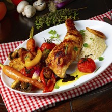 Rustic fried chicken legs with assorted vegetables and rice