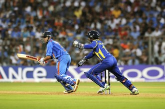 Batsman Gautam Gambhir plays shot Sri Lankan wicketkeeper Sangakkara tries ball 2011 ICC World Cup