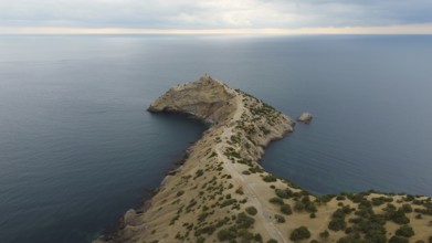 Autumn morning and a mountain landscape by the sea, a promontory protruding into the water