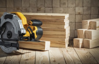 Electric power tool corded circular hand saw on wooden background