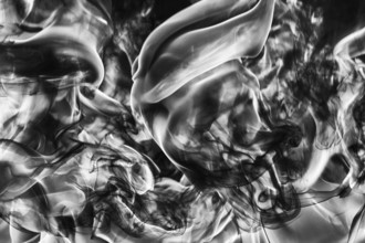 Abstract plume of natural black smoke and white huge flame of strong fire, motion blur from fire,