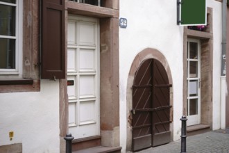 Heavy wooden doors and gates of a shop and residential building in the old town centre