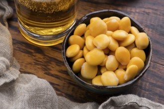 Tasty lupins and glass of beer. Beverage, legume