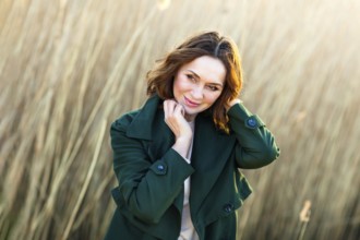 Portrait of a beautiful middle-aged woman posing at sunset