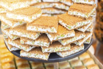 Turkish traditional dessert Kadayif baked in syrup served with nut powder