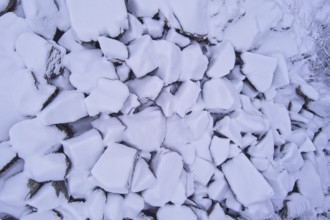 Aerial view of pile of large stones covered with snow in winter, Kuhakoski, Nurmijärvi, Finland,