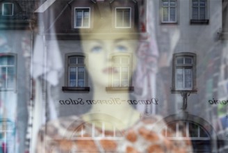 Reflection in a windowpane, women's fashion, Bad Karlshafen, Weser Uplands, Weserbergland, Hesse,