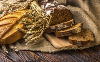 Still life with fresh bread on wooden table