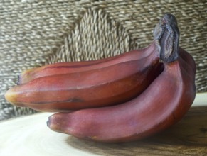 Red bananas on teak wood