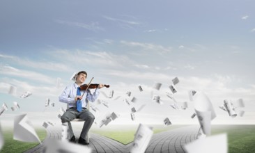 Young businessman is engaged in music, concept of creative chaos in business