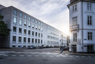 Copenhagen, Denmark, August 10, 2016. Man biking in the street of Copenhagen at sunset with