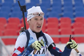 Portrait of Russian sportsman biathlete Ilmir Akhtyamov Saint Petersburg at finish after rifle