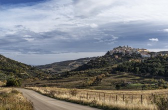 A view of the town of Tolve in Basilicata with a country highway in the foreground
