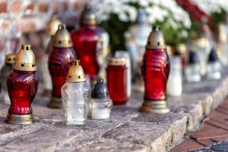 Cemetery with flowers and grave candles on a memorial day