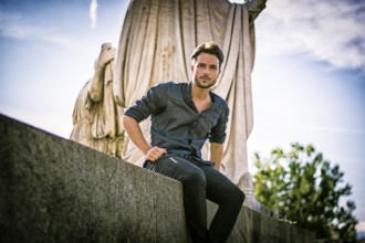 One handsome young man in urban setting in European city, Turin in Italy