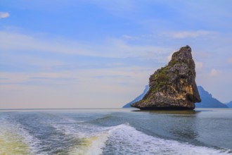Fantastic beauty island-rock in the southern seas. The photo was taken from a fast sailing boat