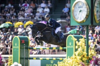 Denis Lynch of Ireland and riding Vistogrand compete in the first round of the 1.60m CPKC