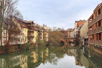 Old buildings and bridge reflected in water in Nuremberg, Bavaria