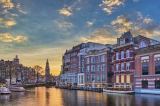 Amsterdam Netherlands, sunset city skyline of Dutch house at canal waterfront