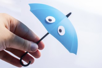 Hand with small tiny umbrella in hand