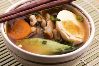 Ramen egg noodle soup dish with salmon fish