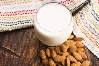Almond milk with almond on a wooden table