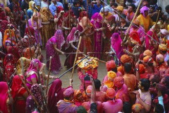 Women beating men with sticks, Lathmar Holi festival, Mathura, Uttar Pradesh, India, Asia
