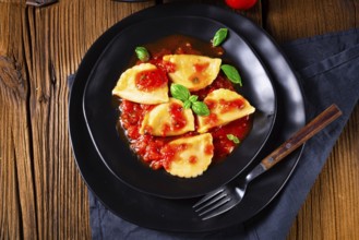 Ravioli alla genovese with basil and tomato sauce