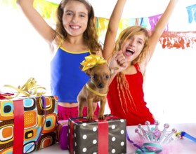 Girl friends party dancing with presents and puppy chihuahua dog in birthday
