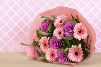 Colorful wrapped pink and purple bouquet in interior