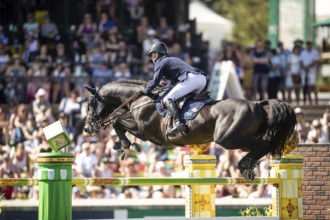 Denis Lynch of Ireland and riding Vistogrand compete in the first round of the 1.60m CPKC