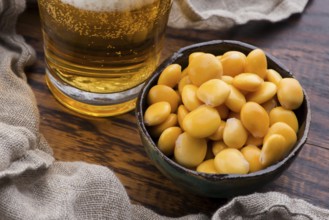 Tasty lupins and glass of beer. Beverage, legume